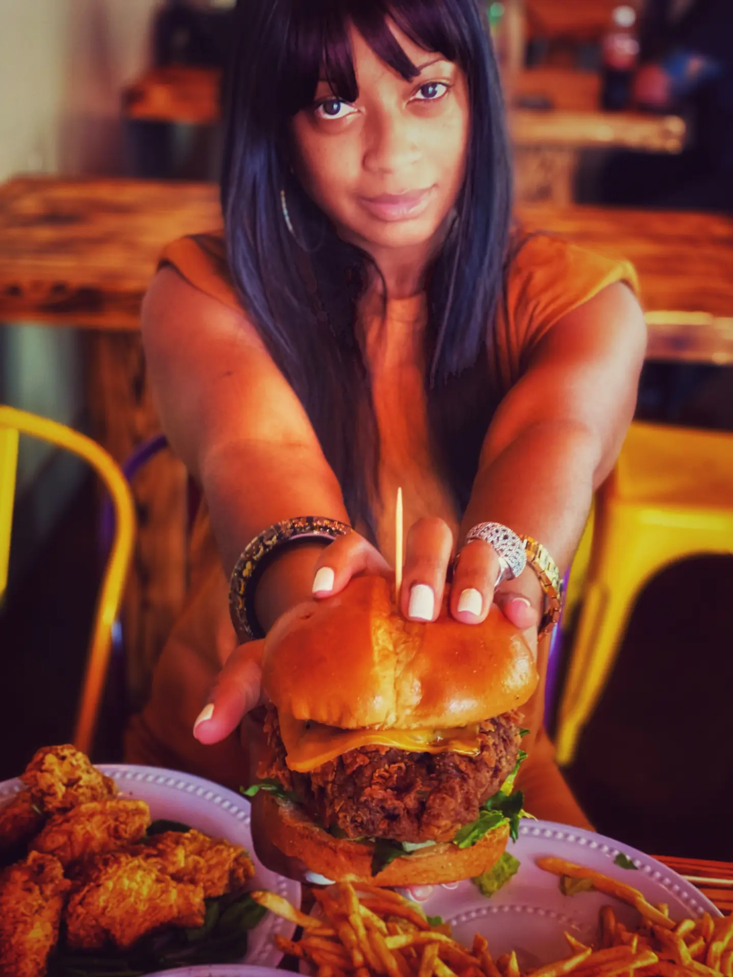 Tiffany Hinton Jefferson, founder of Black Owned Food LA, holding a burger